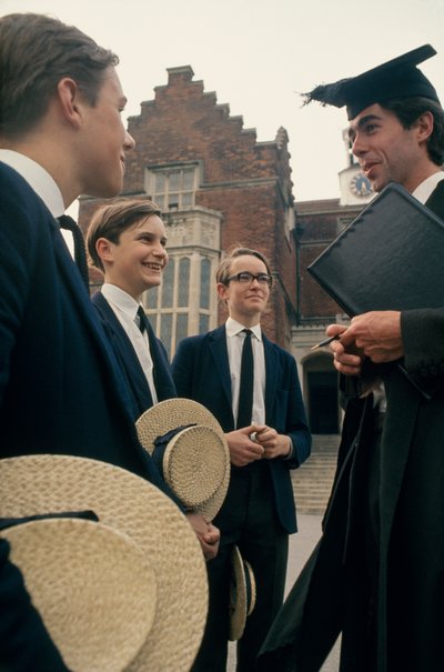 Harrow students consult with a teacher in front of their school by Ted Spiegel