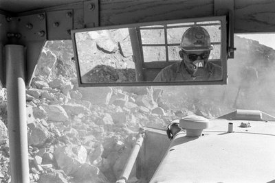 Heavy equipment operator in cab at Open pit copper mine Morenci mine for Phelps Dodge by Ted Spiegel