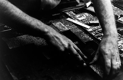 Typesetter sets cold type from linotype machine for the Frontiersman newspaper by Ted Spiegel