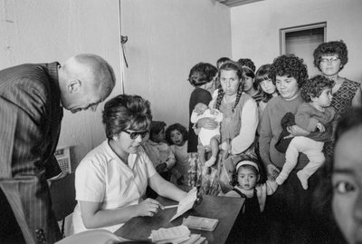 Young mothers with children and babies visiting a Santiago clinic to learn about birth control by Ted Spiegel