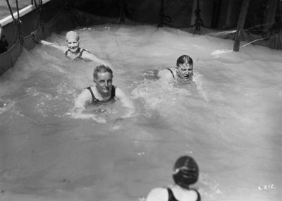 Passengers in the swimming pool on board a cruise ship by Unbekannt