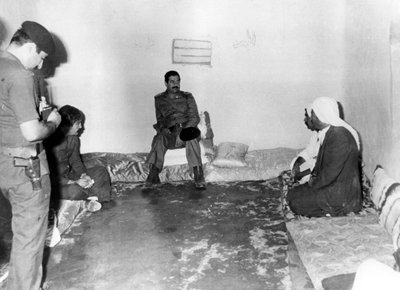 Saddam Hussein Visiting a Peasant House in Basra, Iraq by Unbekannt