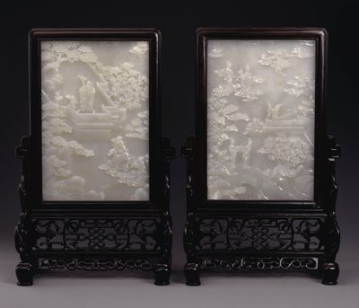 A pair of white jade table screens carved in relief with immortals amid clouds or in gardens with attendants and mythical beasts by Unbekannt