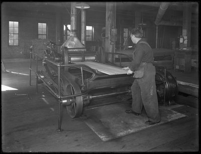 Running Lumber Intended for Use in Casket Manufacture Through a Double-Surface Planer, Oneida, New York, April 3, 1916 by William Davis Hassler