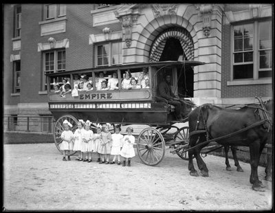Small Girls Pose in and in Front of a Horse-Drawn Wagon, in Front of an Unidentified Building, Probably the Roman Catholic Orphan Asylum, Kingsbridge, Bronx by William Davis Hassler