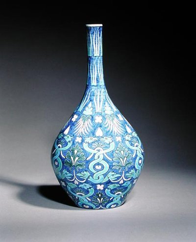 Large bottle shaped vase decorated in the Persian style with intertwined snakes and leaf motifs by William de Morgan