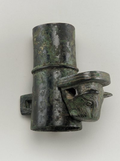 Hubcap with linchpin cast in the form of a feline head by Zhou Dynasty Chinese School