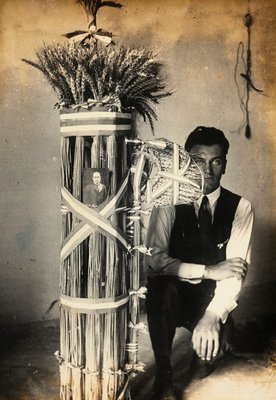 Antonio Floridi posing near fasces of lictors made of ears of wheat. Farm owned by Camillo Frizzoni, in Morengo, province of Bergamo. On top of the fasces is a photo of Mussolini  by F. Frizzoni