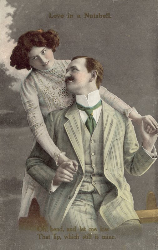 Fashionably dressed couple about to kiss by English Photographer