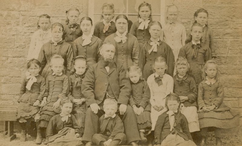 Teacher Posing for a Portrait with His Pupils by English Photographer