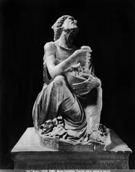Statue of an old drunken woman holding a wineskin