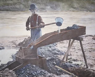 American gold prospector using a sluice box