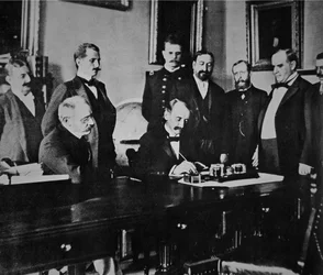 President William McKinley witnesses the signing of the Peace protocol that ended the war with Spain