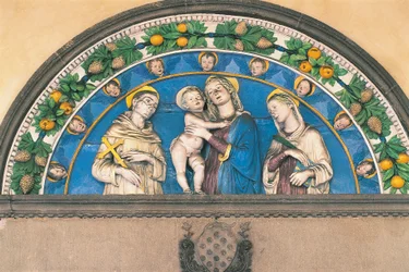 Glazed terracotta lunette depicting Madonna with Child between Saints