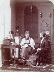 Composition a la russe: interior of a Russian home with man and woman embroidering and dressed in traditional costume. Photograph by Andrei Osipovich Karelin (1837-1906), 1870-1880. State Museum of History, Moscow