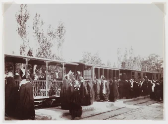 Veiled women boarding a train