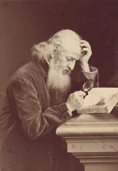 Bearded Man with Magnifying Glass Examining a Manuscript