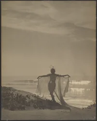 Back View of a Dancer Wearing a Sheer Costume at the Beach