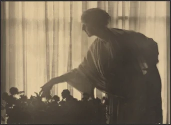 Woman Tending Flowers Inside Her Apartment