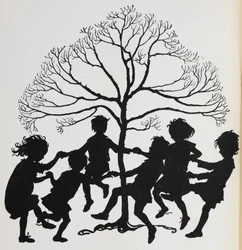 Silhouette of children dancing around a tree