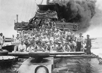 Group portrait of some unidentified members of the crew of HMAS Sydney, shown on the deck while their ship is chasing the collier Buresk near Cocos Island, 9 November 1914