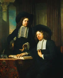 Two Gentlemen, One Seated at a Table