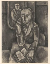 Man Sitting at a Table with an Open Book