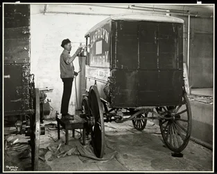A Man Spraypainting a Delivery Wagon of the Carolyn Laundry at 111 East 128th Street, East Harlem, New York, 1929