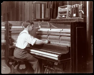 A man working in the Harrington Piano Co. factory, 1907