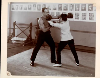 Edna Wallace Hopper posed in a boxing ring with Jack Cooper at his gymnasium at Broadway and 37th Street, New York, 1899