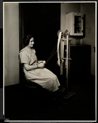 Portrait of a blind, deaf and dumb young woman spinning wool at the New York Association for the Blind, 111 East 59th St., New York
