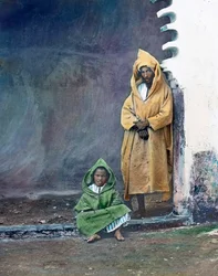 Morocco, Moorish Merchant with Little Son, Image Date: circa 1910. Carl Simon Archive