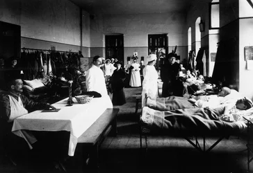 Decorated Salon at a Hospital with War Wounded, Doctors, Red Cross Nurses and Visitors