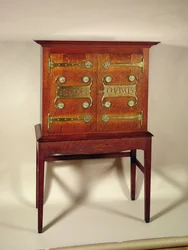 The Kelmscott Chaucer cabinet, designed by C.F.A. Voysey and made by F. Coote, 1899