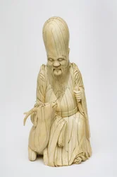 Carved Ivory figure of Shou Xing seated with deer, c.1580-1644
