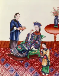 Elegant Chinese lady smelling a flower