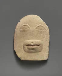 Limestone votive relief of eyes and a mouth (limestone)