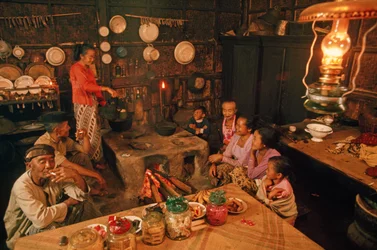 A family sits together before dinner. Tenggerese, Java, Indonesia