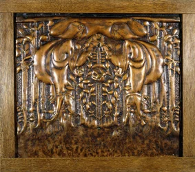 A decorative lead panel moulded in high relief, depicting two facing stylised maidens