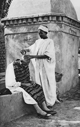 A street barber and his client, Algeria, Africa, 1922