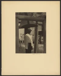 [Black Man Standing Under a Bell]