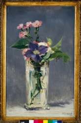 Carnations and clematis in a crystal vase