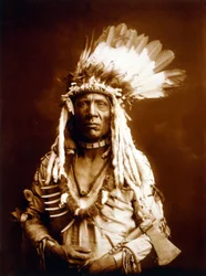 Weasel Tail, Piegan, with a Tomahawk, c. 1900