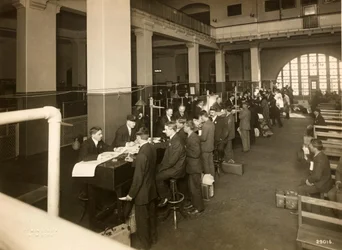 Immigrants Being Registered in the Main Hall, U. S. Immigration Station, 1902-10