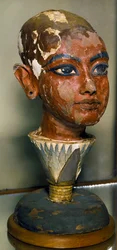 Egyptian Antiquities: Portrait of the Young Pharaoh Tutankhamun Supported by a Lotus Leaf. Painted Wood Carving. From the Treasure of Tutankhamun