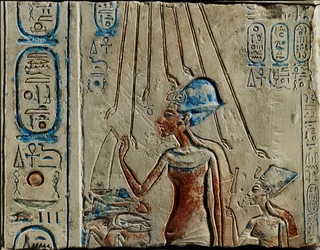Pharaoh Akhenaten and Nefertiti offer libation to God Aten