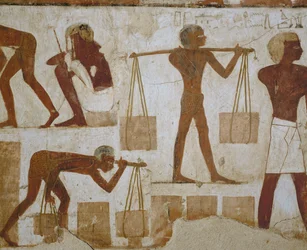 Workmen carrying building materials