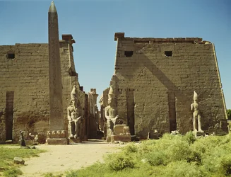 Facade and First Pylon with two seated statues of Ramesses II and the remaining obelisk