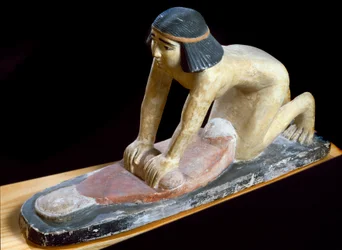 Egyptian antiquity: Egyptian crushing cereals to make bread. Figurine