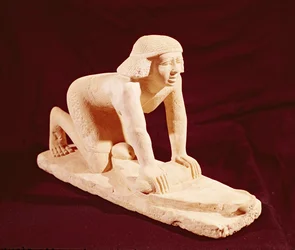 Model of a servant grinding grain, Old Kingdom, from Saqqara